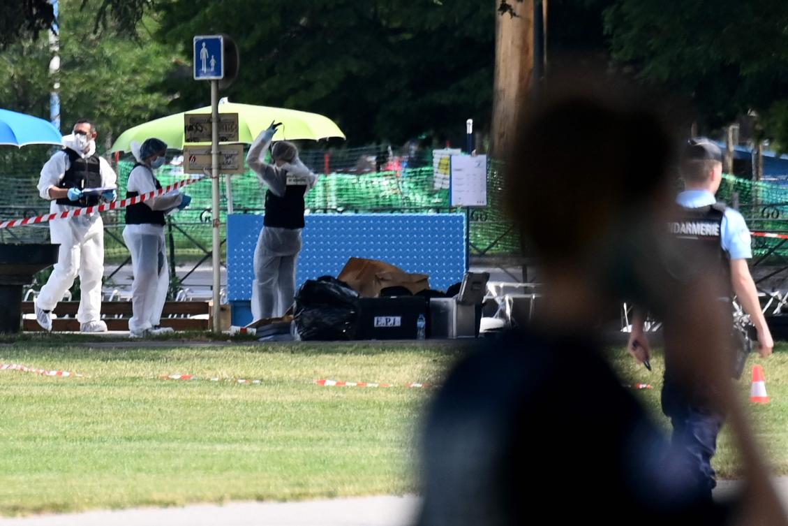 French forensic police officers work at the scene of a stabbing attack in the 'Jardins de l'Europe' park in Annecy, in the French Alps, on June 8, 2023. (AFP)