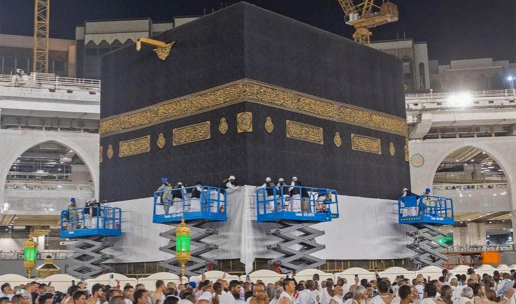 The picture shared by Saudi Press Agency on June 10, 2023, shows officials raising kiswa, the black cloth covering the Kaaba, ahead of the annual Hajj pilgrimage in Makkah, Saudi Arabia. (Saudi Press Agency)