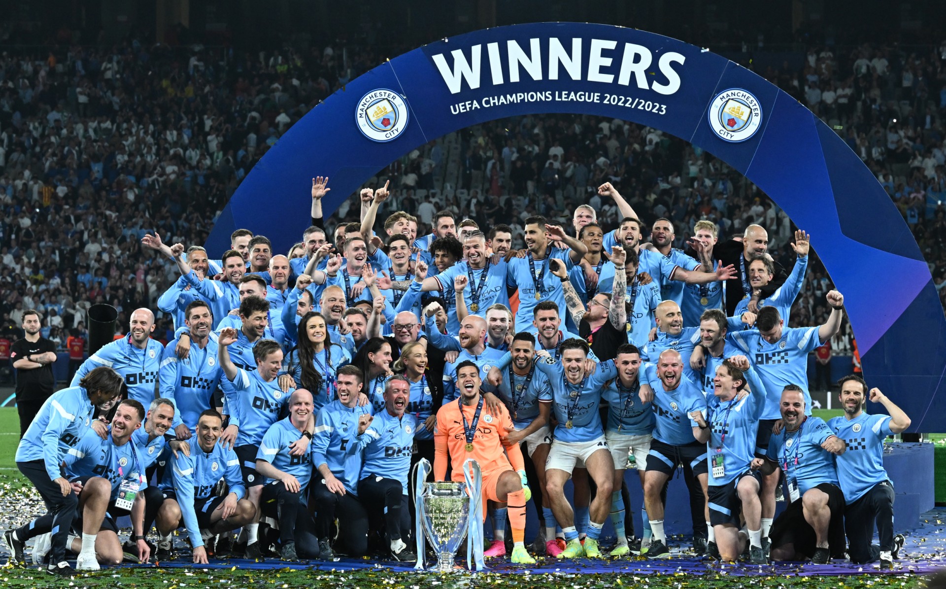 Manchester City's Brazilian goalkeeper #31 Ederson and teammates pose with the European Cup trophy as they celebrate winning the UEFA Champions League final football match between Inter Milan and Manchester City at the Ataturk Olympic Stadium in Istanbul (AFP)
