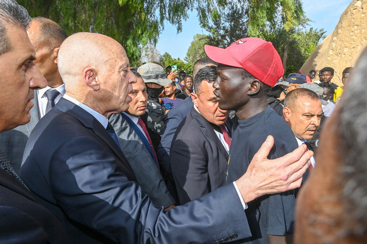 Tunisian President Kais Saied speaks with families living in the camp, and pleaded for international aid for Africans who converge on Tunisia as a transit point to reach Europe. (AFP)