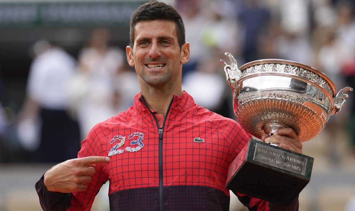 Serbia's Novak Djokovic points at 23 on his garment as he celebrates winning the men's singles final of the French Open tennis tournament against Norway's Casper Ruud in three sets, 7-6, (7-1), 6-3, 7-5, at the Roland Garros stadium in Paris, Sunday. (AP)