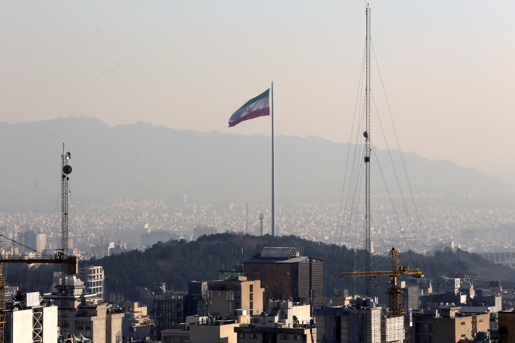 A general view shows the Iranian capital Tehran on January 7, 2023, with the Iranian flag fluttering in the wind. (AFP)