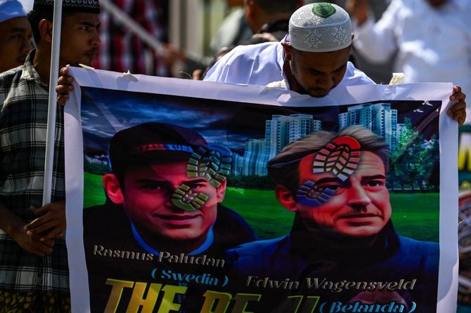 Demonstrators hold banner as they take part in a rally in Banda Aceh on February 3, 2023, to protest after copies of the Qur'an were set on fire in Stockholm and torn apart in the Hague. (AFP/File)