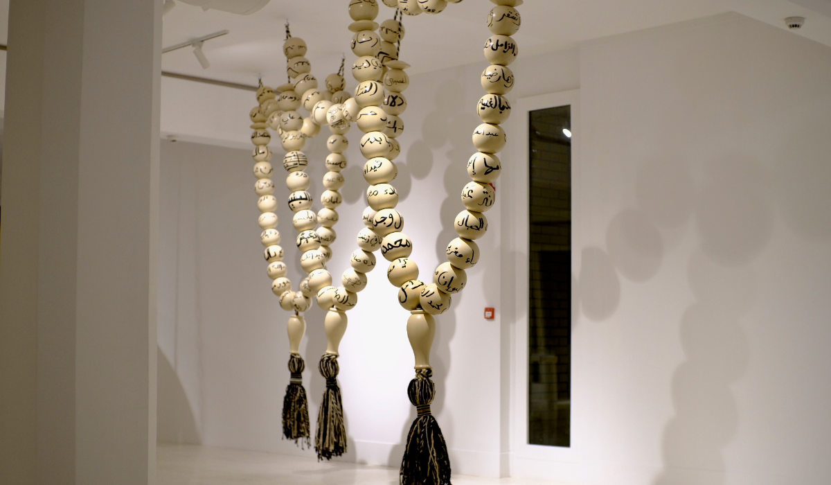 In 2012, Saudi artist Manal AlDowayan collected a group of female Sadu weavers, marginalized by the oil boom, and had each of them paint their names on Maplewood pearls. Strung together and suspended, this collective art piece became one of her most notable participatory works, titled “Esmi (My Name).” (AN Photo Nada Alturki)