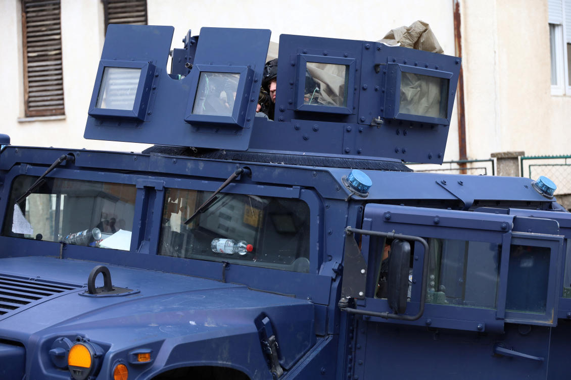Kosovo special police officers sit in a vehicle, after the arrest of a Serb identified as an organiser of violent protests last month, in Mitrovica, on June 13, 2023. (Reuters)