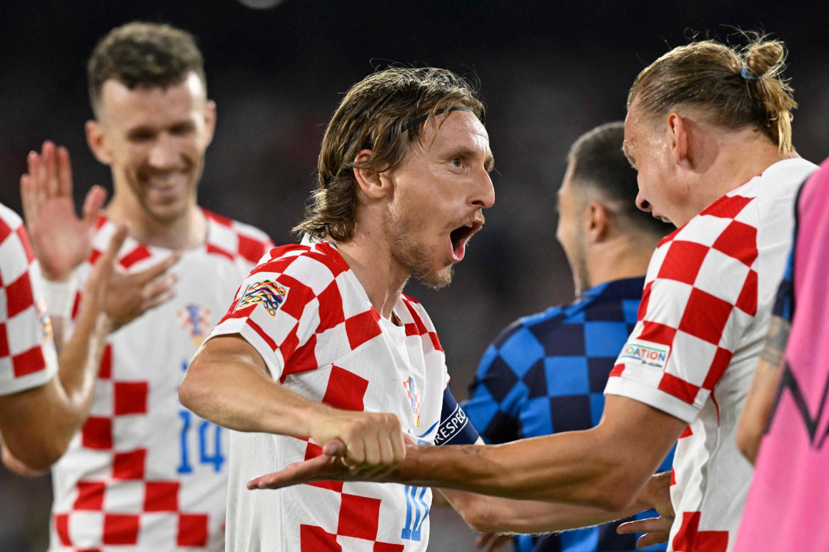 Croatia's midfielder Luka Modric (C) celebrates with Croatia's defender Domagoj Vida after scoring his team's fourth goal during the UEFA Nations League semifinal against The Netherlands at the De Kuip Stadium in Rotterdam on Wednesday. (AFP)