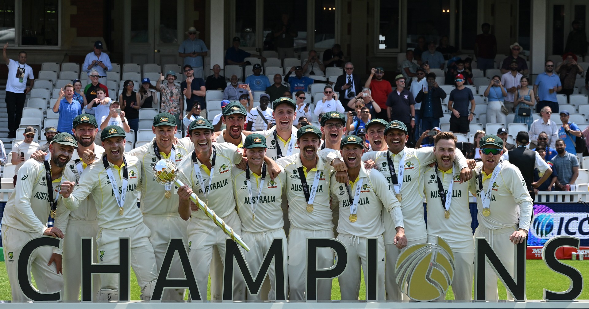 Australia's Pat Cummins (C/L) lifts the ICC Test Championship Mace as he celebrates with teammates after victory in the ICC World Test Championship cricket final match between Australia and India at The Oval, in London (AFP)