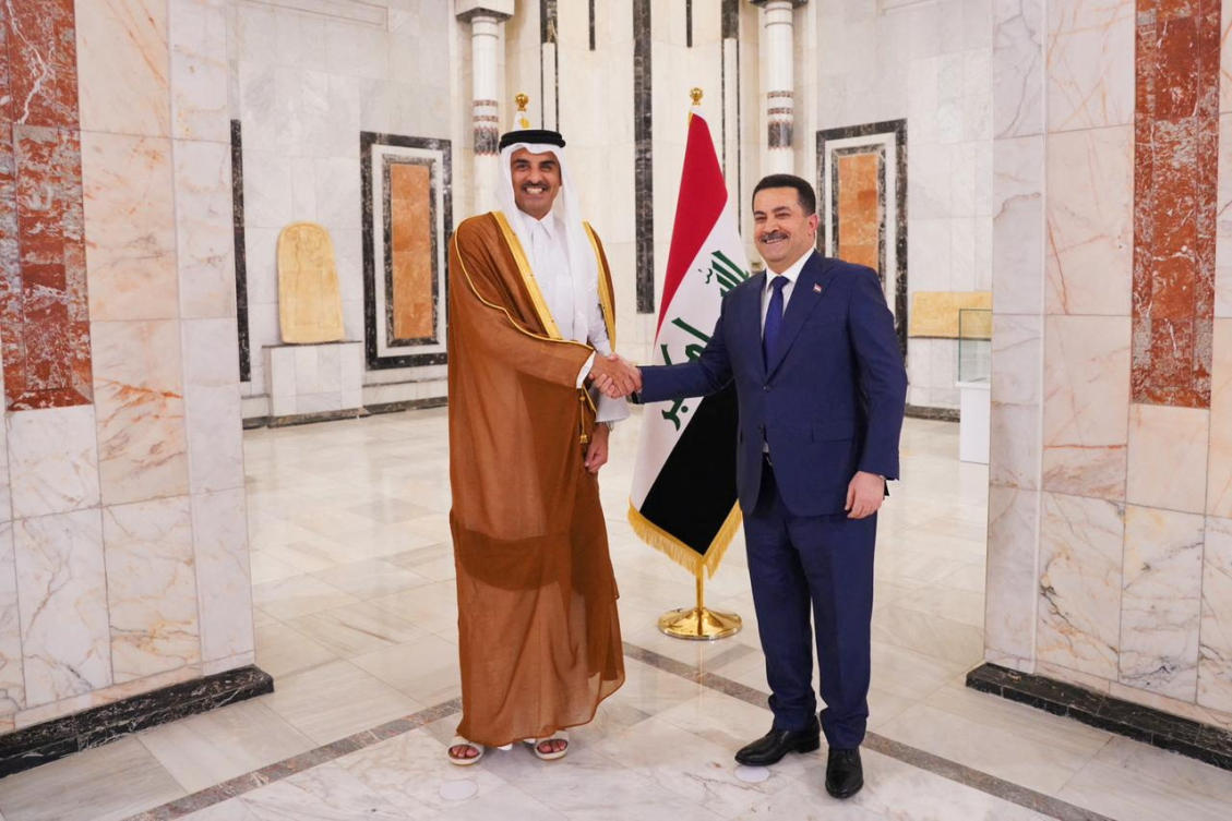 Iraqi Prime Minister Mohammed Shia al-Sudani shakes hands with Qatar's Emir Sheikh Tamim bin Hamad al-Thani during a welcome ceremony, in Baghdad, Iraq. (Reuters)