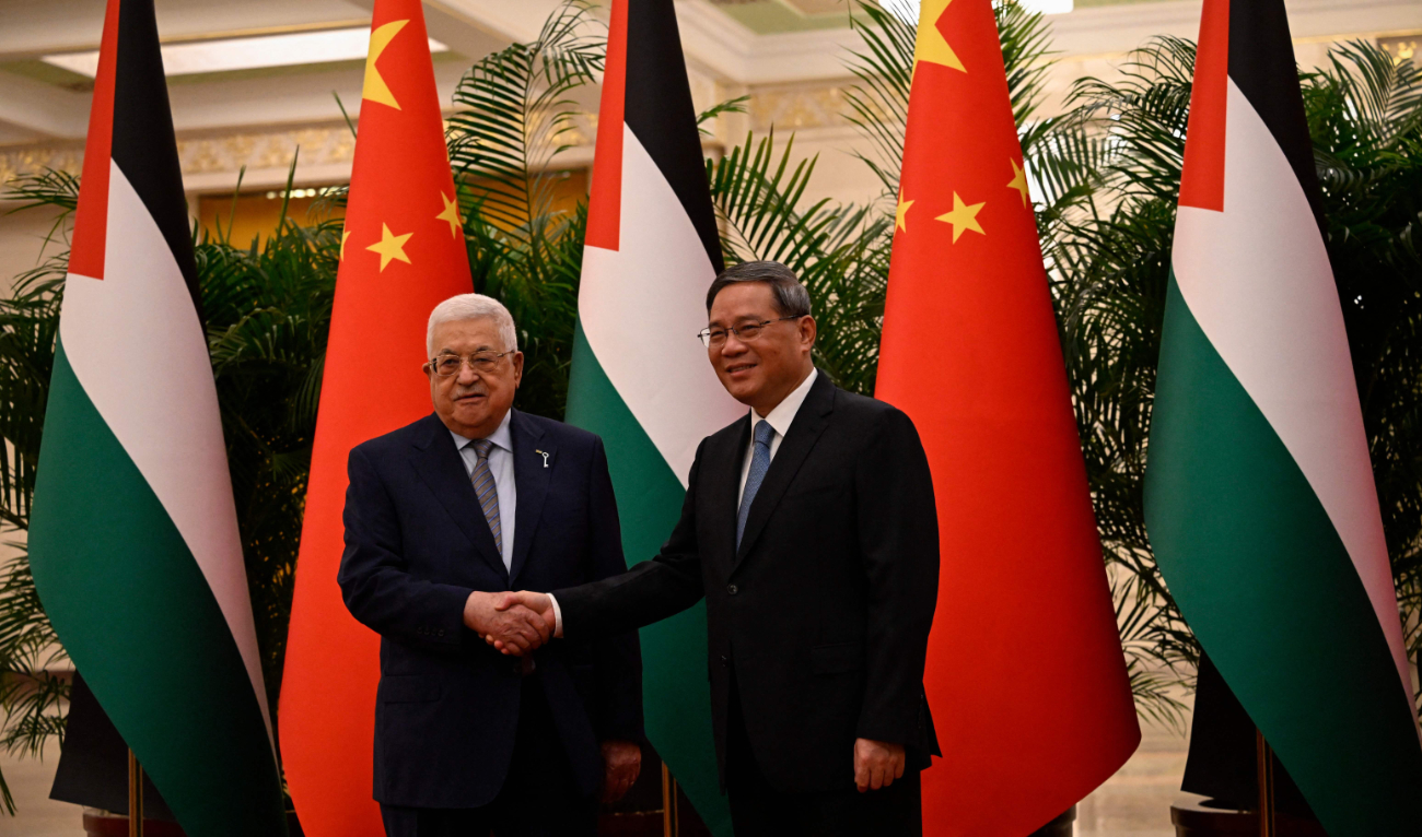 Chinese Prime Minister Li Qiang receives Palestinian President Mahmoud Abbas at the Great Hall of the People in Beijing on Thursday. (AFP)