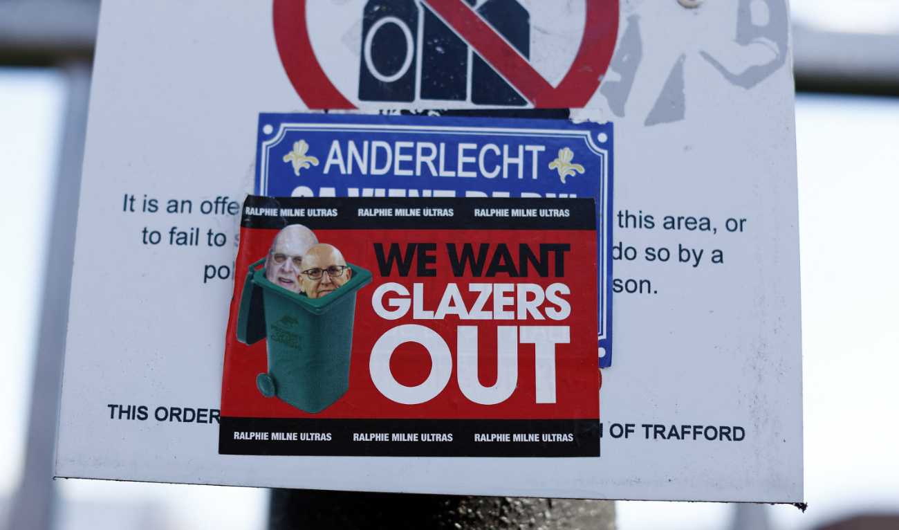 Manchester United has over 650 million fans worldwide, according to market research firm Kantar. A large number of them have been clamoring for a change of ownership. Photo shows sticker directed at Manchester United co owners Joel Glazer and Avram Glazer outside Old Trafford. (Reuters)