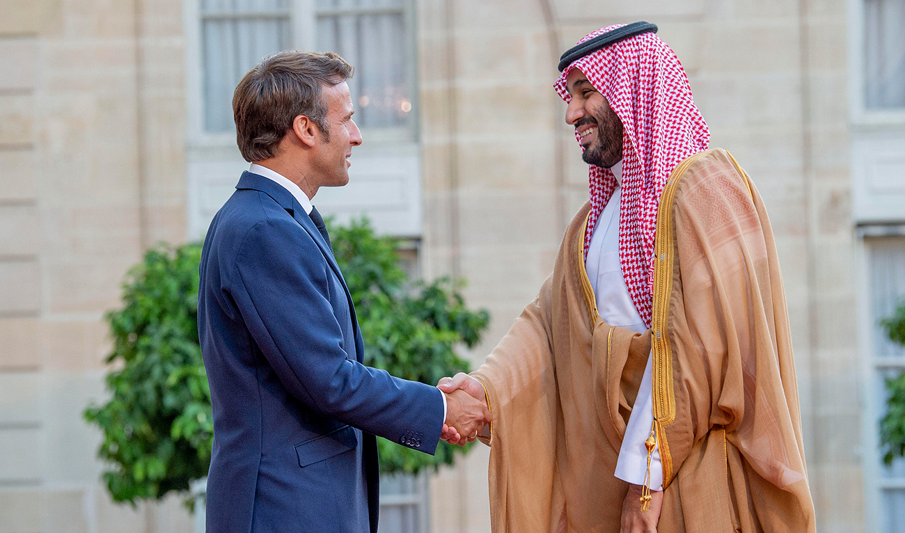 A handout picture provided by the Saudi Royal Palace shows French President Emmanuel Macron welcoming Saudi Crown Prince Mohammed bin Salman in Paris on July 28, 2022. (Photo courtesy: Saudi Royal Palace via AFP/File)