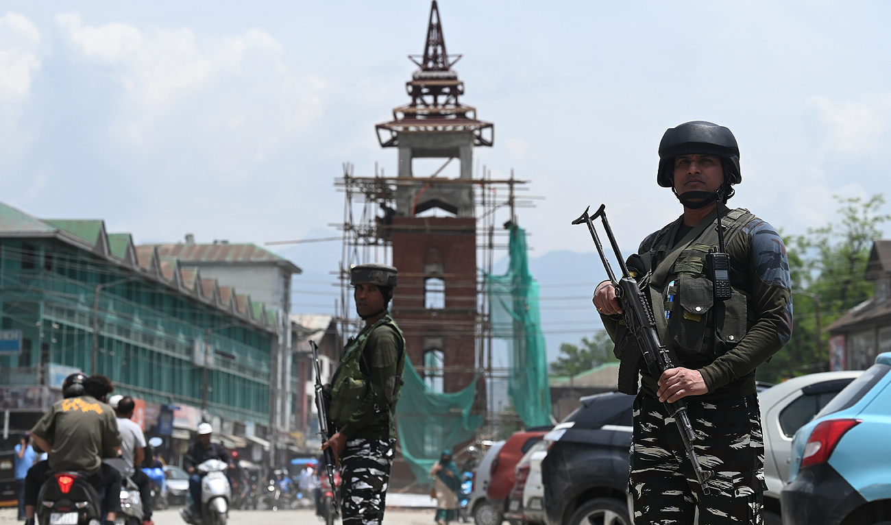 Indian paramilitary troopers stand guard along a road in Srinagar on May 16, 2023. (AFP)