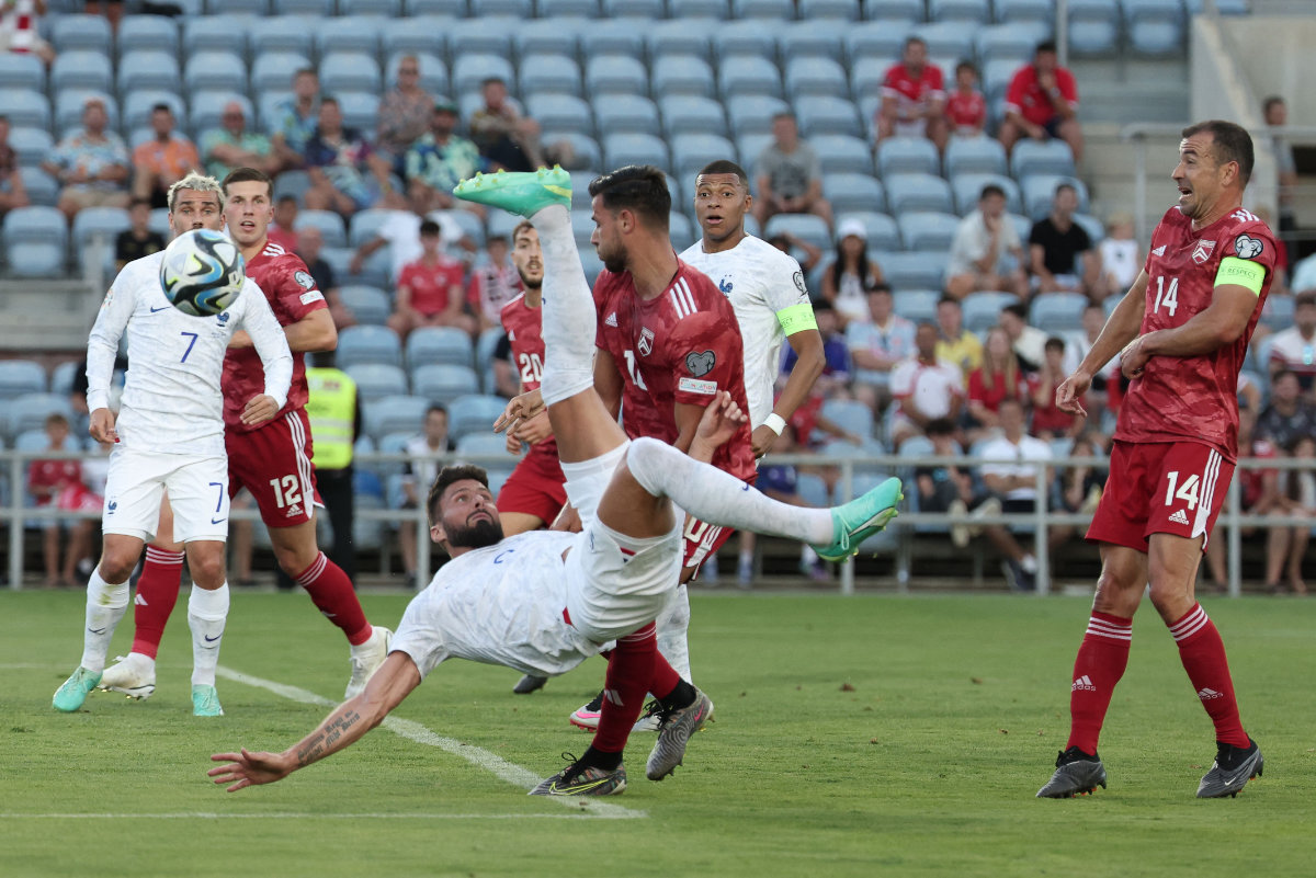 Players react as France's forward Olivier Giroud (C) does a scissor kick during the UEFA Euro 2024 Group B qualification football match between Gibraltar and France at the Algarve stadium in Faro on Friday. (AFP)