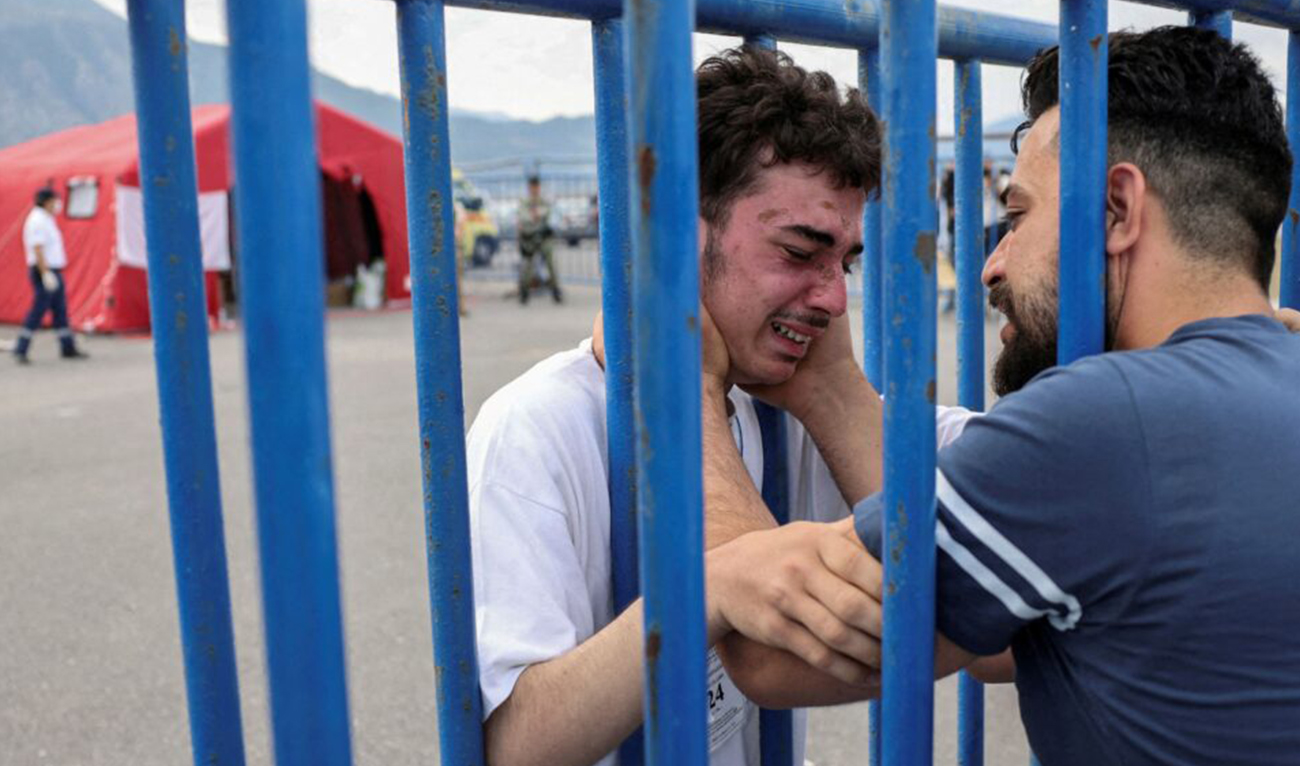 Syrian survivor Mohammad, 18, who was rescued with other refugees and migrants at open sea off Greece after their boat capsized, cries as he reunites with his brother Fadi, who came to meet him from Netherlands, at the port of Kalamata, Greece, on June 16, 2023. (Reuters)