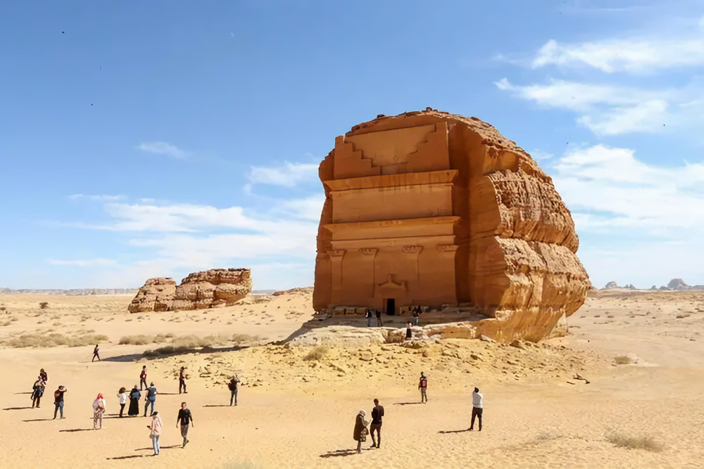 Visitors are seen in front of Qasr Al-Farid tomb at the Madain Saleh antiquities site in Al-Ula, Saudi Arabia, Jan. 31, 2020. (Reuters)