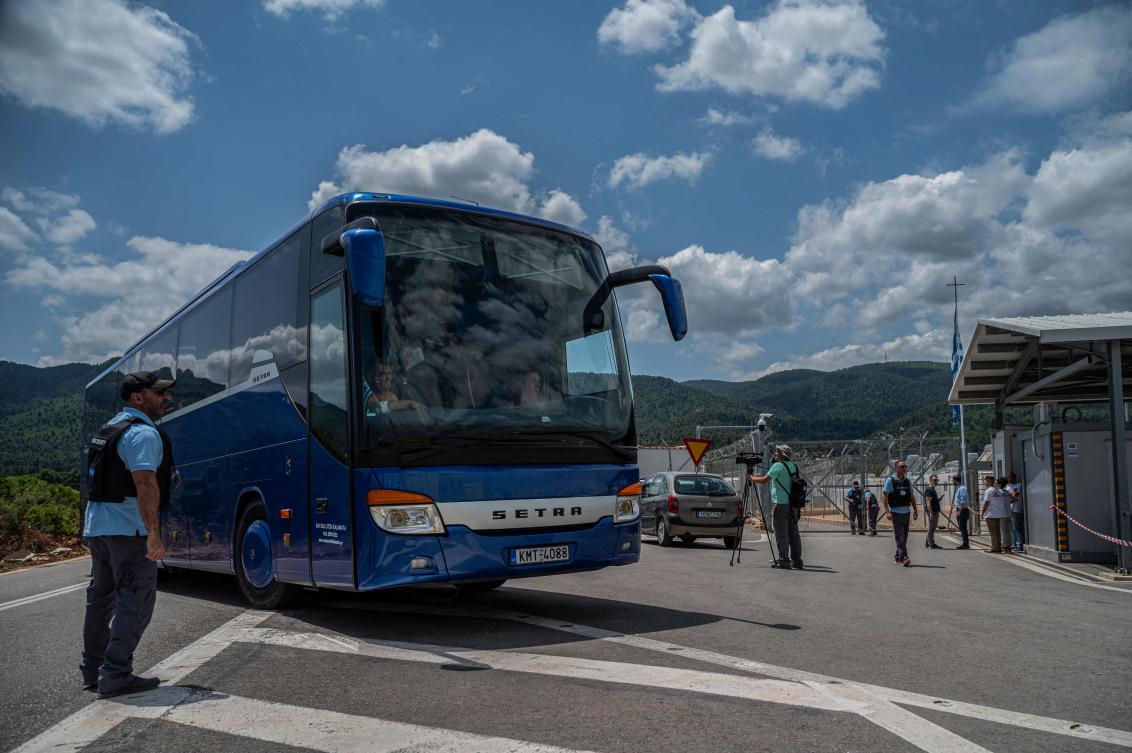 A bus with survivors of a shipwreck enters a migrant camp in Malakasa, near Athens on June 16, 2023, after a boat carrying dozens of migrants sank in international waters in the Ionian Sea. (AFP)