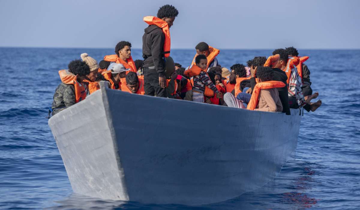 Migrants from Eritrea, Libya and Sudan crowd the deck of a wooden boat in the Mediterranean Sea as they wait to be assisted by aid workers. (AP)