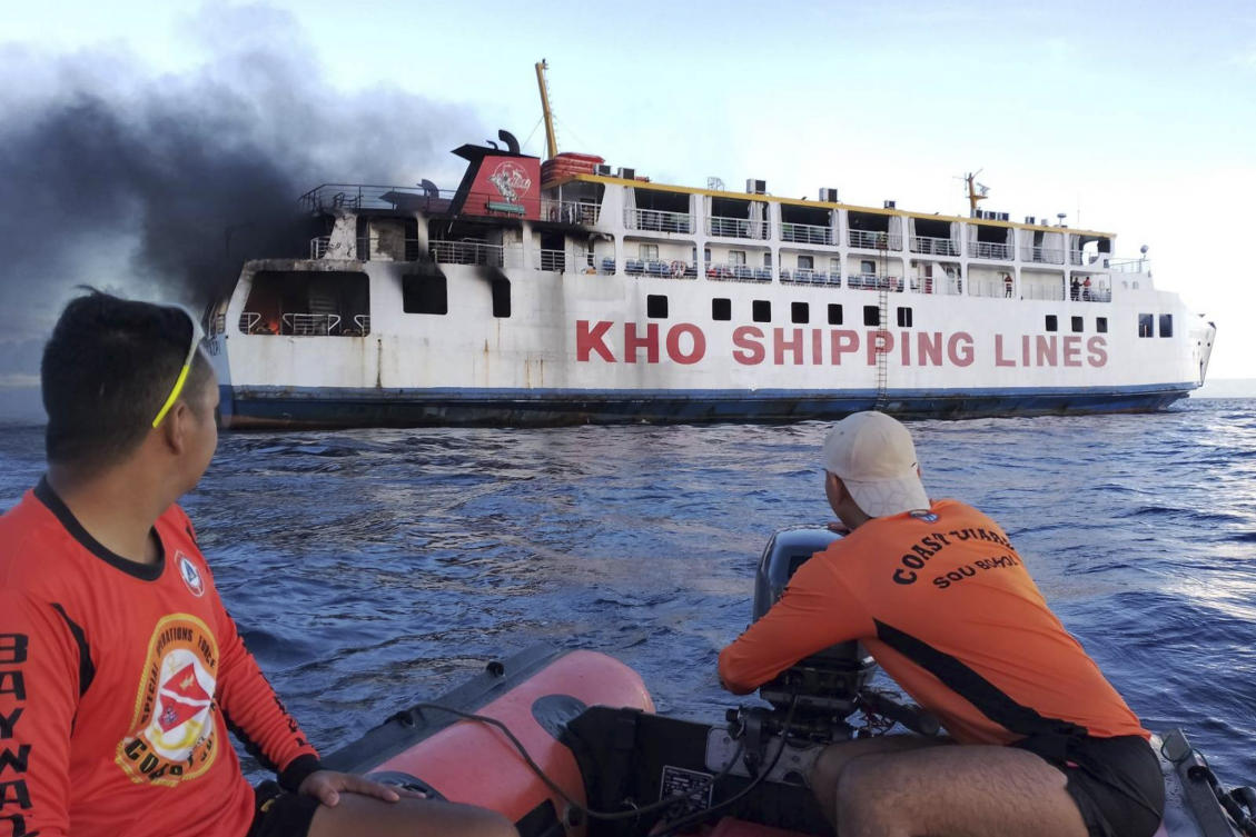 In this handout photo provided by the Philippine Coast Guard, the coast guard personnel assist in putting out the fire on Philippine ferry M/V Esperanza Star at the waters off Panglao, Bohol province, central Philippines on Sunday, June 18, 2023. (AP)