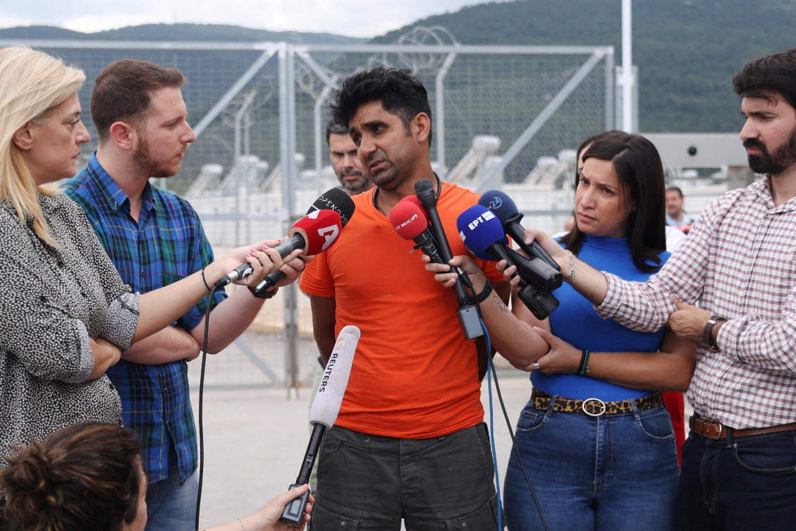 Pakistani Adil Hussain, who says his brother Matloob, 43, was onboard a boat with migrants that capsized at open sea off Greece, speaks with journalists at a migrant camp near Athens. (Reuters)