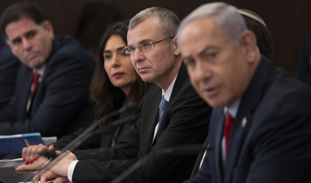 Israeli Prime Minister Benjamin Netanyahu(R)and Minister of Justice Yariv Levin (2-R) attend a weekly cabinet meeting in the prime minister's office in Jerusalem, on June 18, 2023. (AFP)