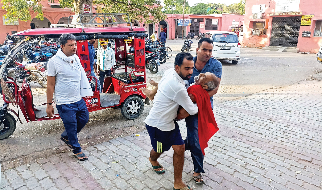 An elderly man is carried to a hospital in northern Uttar Pradesh, India, on Sunday after collapsing due to heat. Around 100 people have died so far UP and Bihar. (AP)