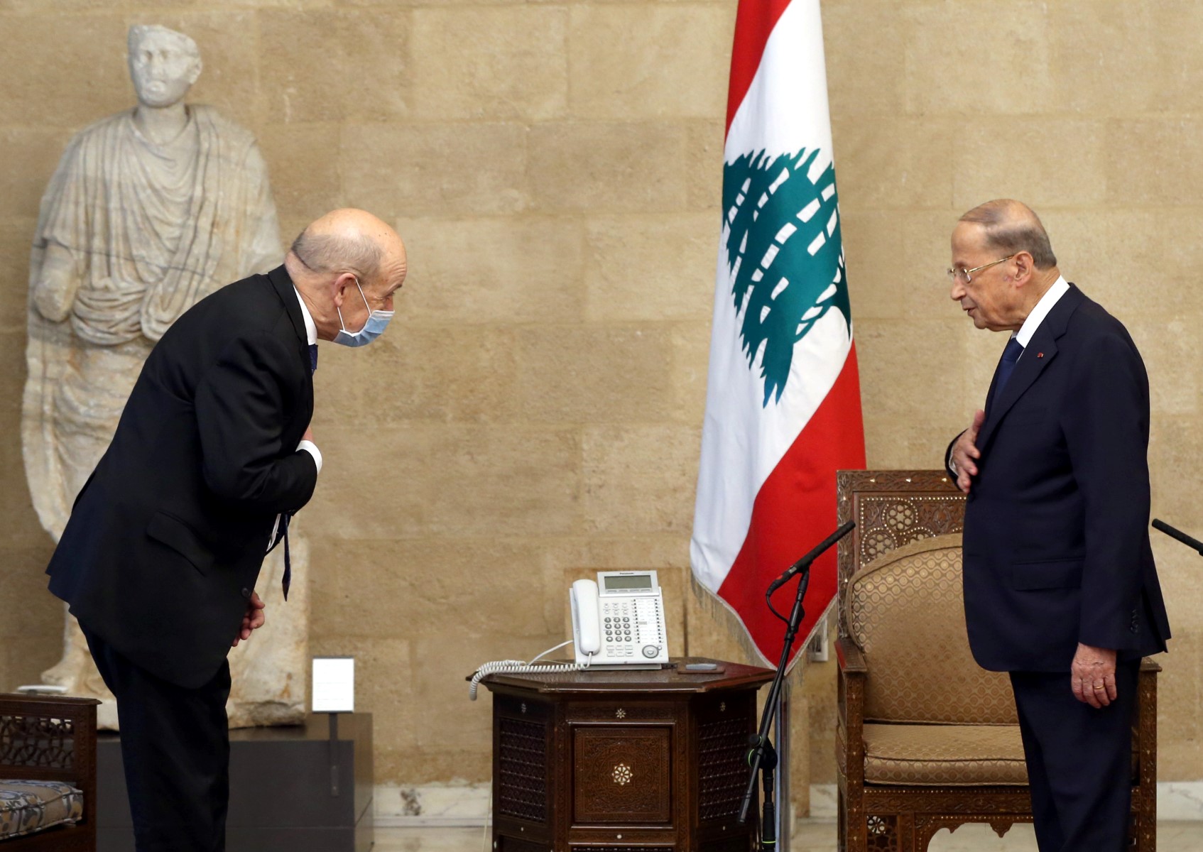 A file photo of Lebanon's President Michel Aoun (R) welcoming French Foreign Minister Jean-Yves Le Drian at the presidential palace in Baabda (AFP)