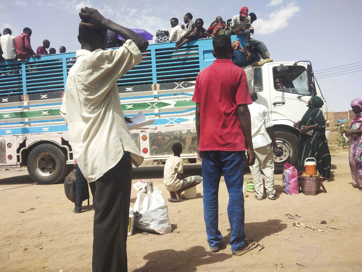 People board a truck as they leave Khartoum, Sudan, Monday, June 19, 2023. (AP)