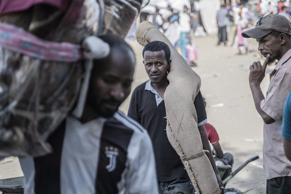 Refugees from Sudan who crossed into Ethiopia carry their belongings in Metema on May 5, 2023. (AFP)