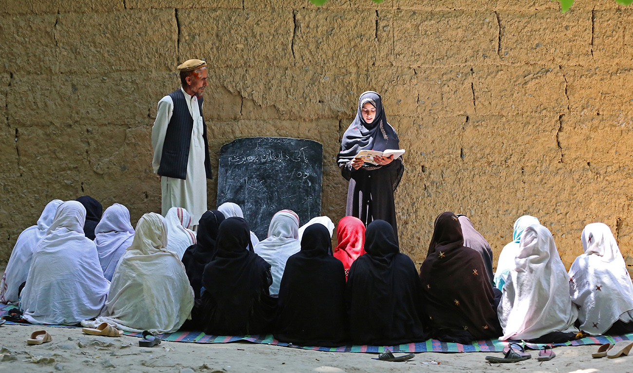 Afghan school girls attend a class at an open air primary school in Khogyani district of Nangarhar province on May 14, 2023. (AFP/File)