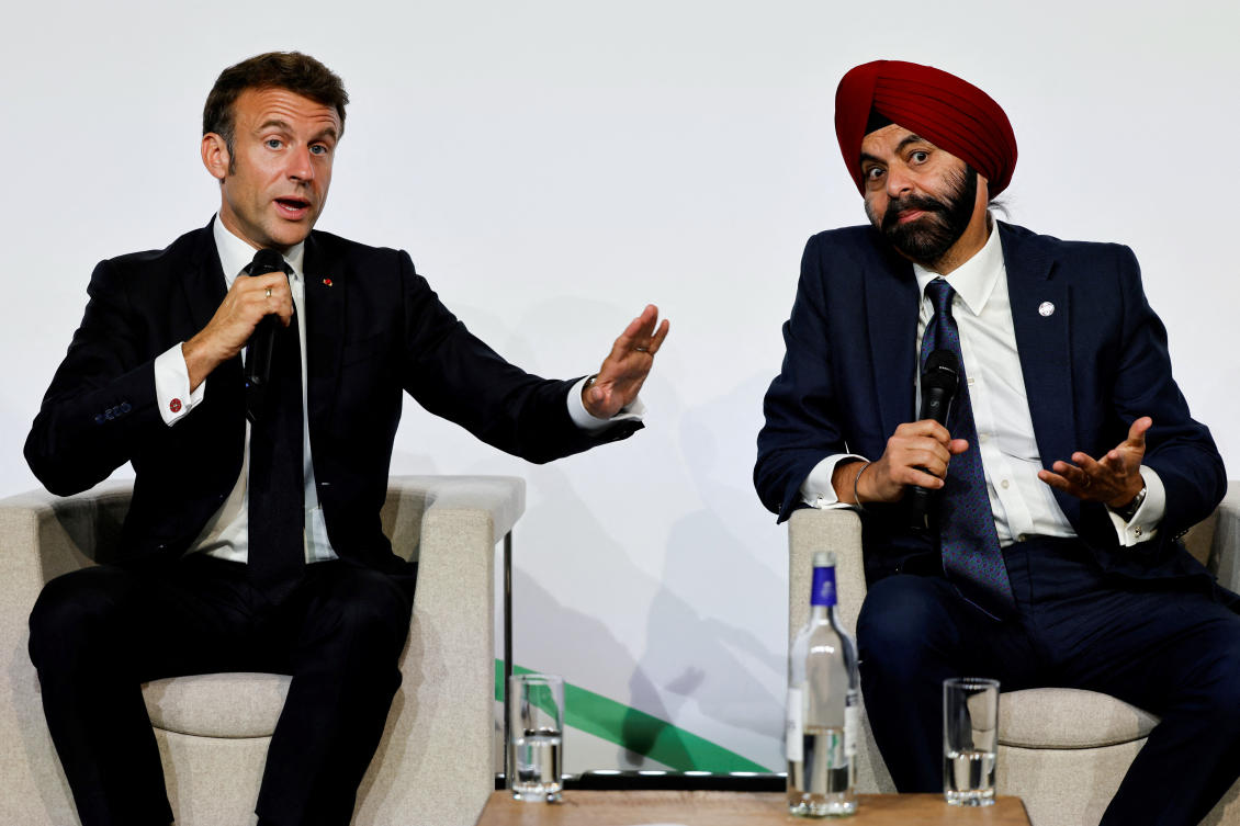 French President Emmanuel Macron gestures as he takes part in a round table discussion next to World Bank President Ajay Banga during the New Global Financial Pact Summit at the Palais Brongniart in Paris. (Reuters)