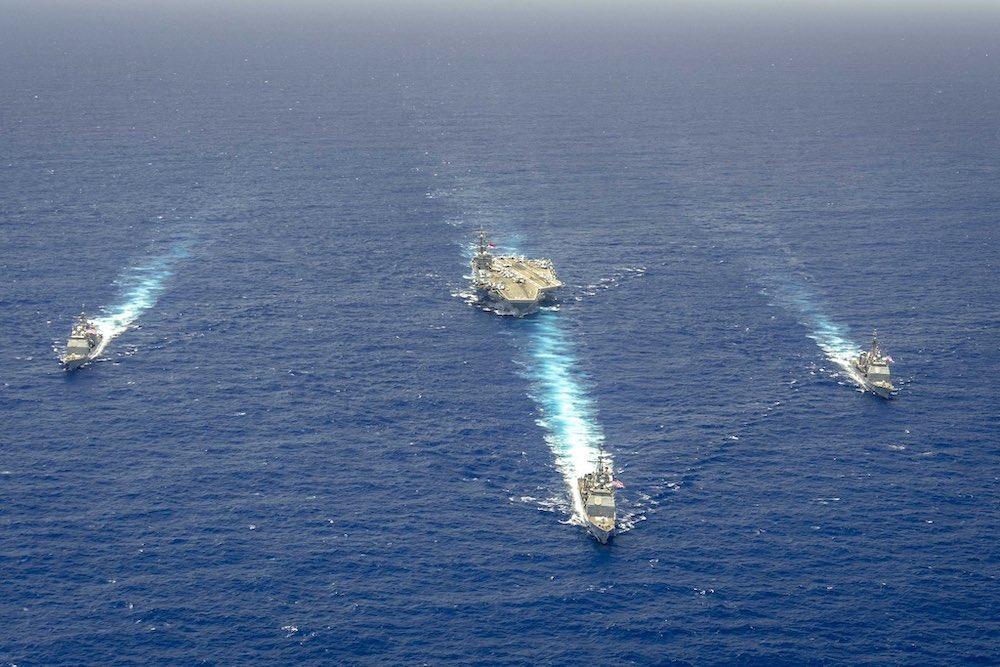 The USS Ronald Reagan, at center back, in formation with support warships in the Philippine Sea. (Twitter: @Gipper_76)
