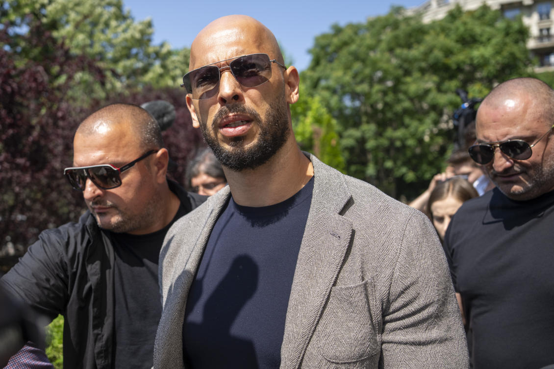Andrew Tate walks between bodyguards as he arrives at the Bucharest Tribunal, in Bucharest, Romania, on June 21, 2023. (AP)