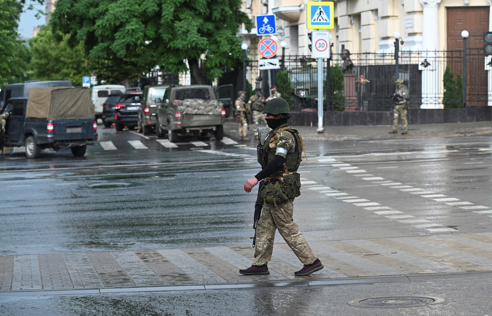 Fighters of Wagner private mercenary group stand guard in a street near the headquarters of the Southern Military District in the city of Rostov-on-Don, Russia on June 24, 2023. (Reuters)