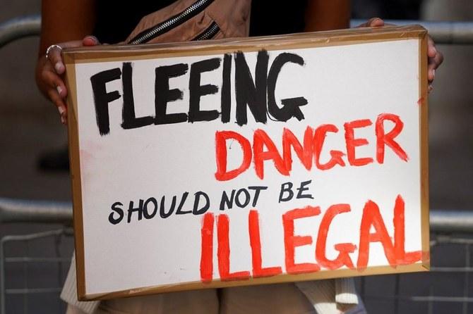 A protester stands outside the Home Office in central London to demonstrate against the UK government’s intention to deport asylum-seekers to Rwanda. (File/AFP)