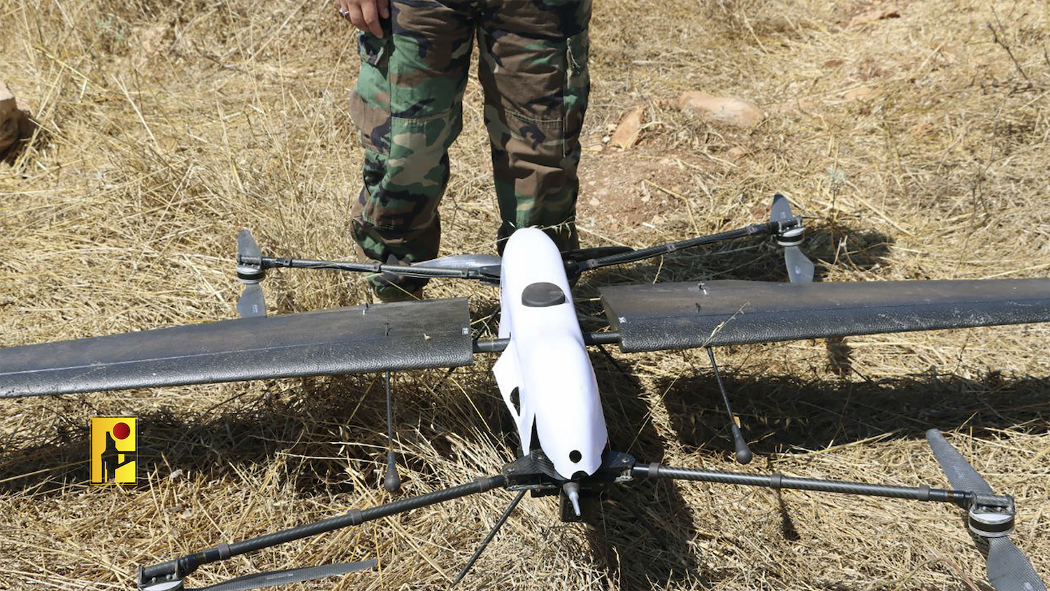 A Hezbollah fighter stands next to an Israeli drone in southern Lebanon on Monday, June 26, 2023. (AP)