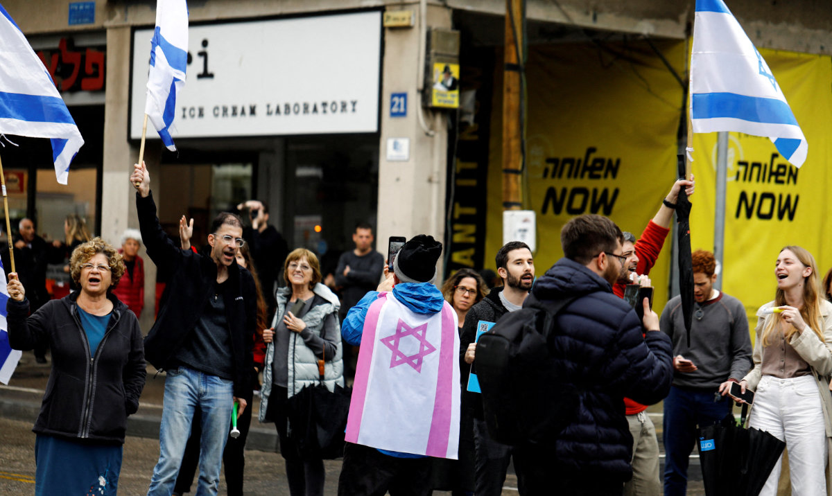 Members of Israel’s hi-tech sector hold flags during a protest, as Israeli Prime Minister Benjamin Netanyahu’s nationalist coalition government presses on with its judicial overhaul, in Tel Aviv, Israel, March 14, 2023. (Reuters)