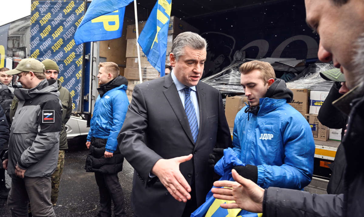 Russia's Liberal-Democratic Party of Russia (LDPR) leader Leonid Slutsky (C) greets volunteers before they start the party's humanitarian aid convoy to Eastern Ukraine in front of the State Duma building in Moscow on March 2, 2023. (AFP)