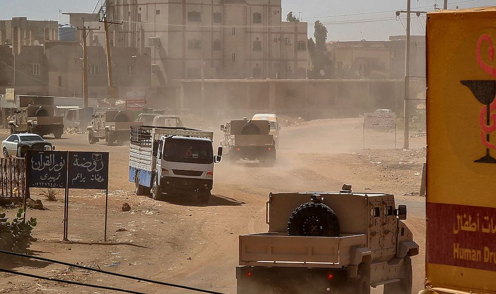 Sudanese army armored vehicles drive in a street in Khartoum, on June 26, 2023. Sudan’s army today faced a multi-front challenge after losing a Khartoum police headquarters to paramilitaries in a battle that killed at least 14 civilians, while rebels attacked troops. (AFP)