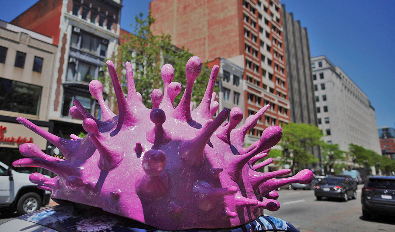 A model of a coronavirus virion sits on top of a car advertising home test kits for COVID-19 in Boston, Massachusetts, U.S., onn May 24, 2022. (REUTERS/File)