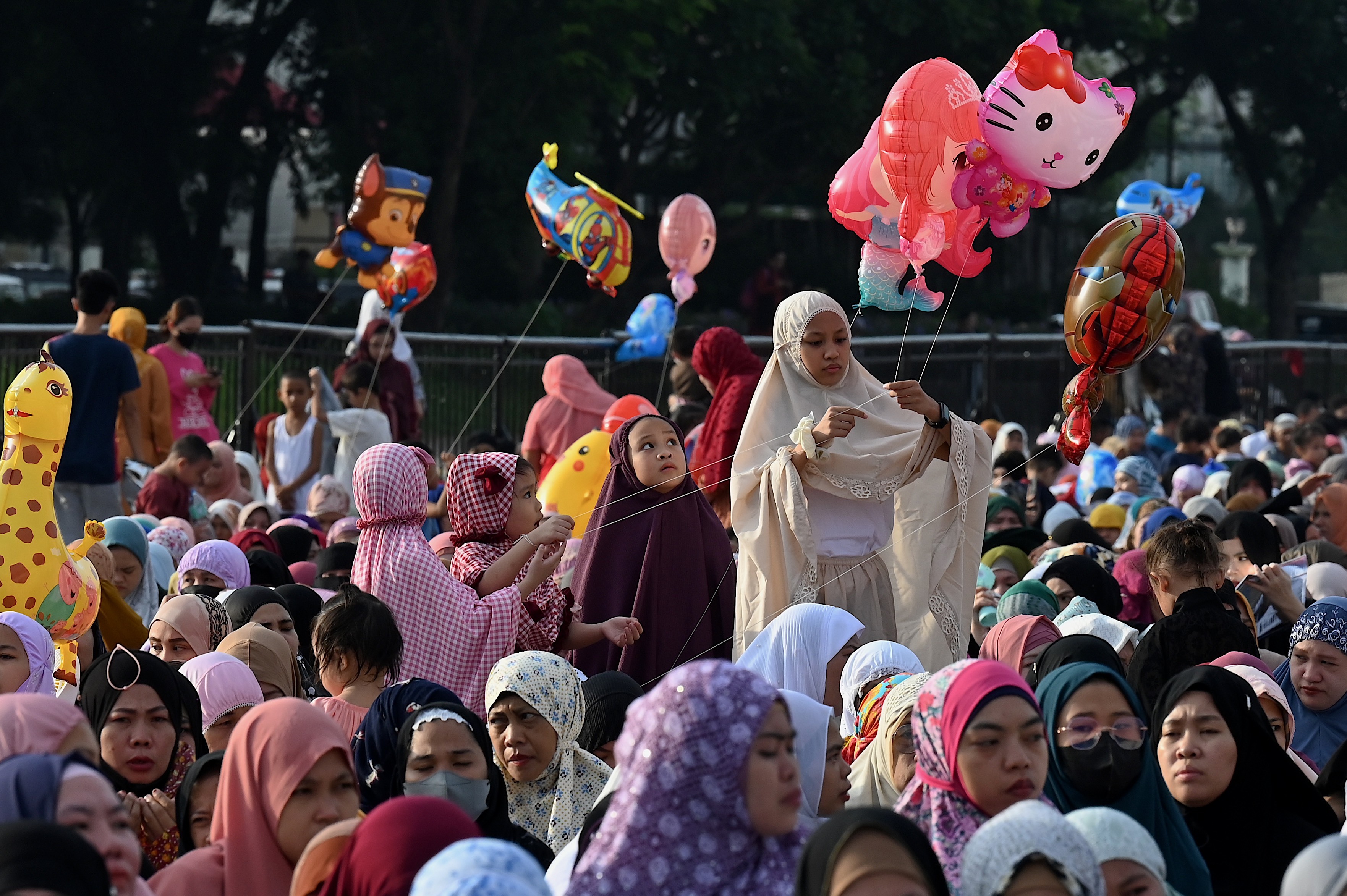 Muslims take part in a morning prayer celebrating the feast of Eid Al-Adha at the Quirino Grandstand in Manila. (AFP)