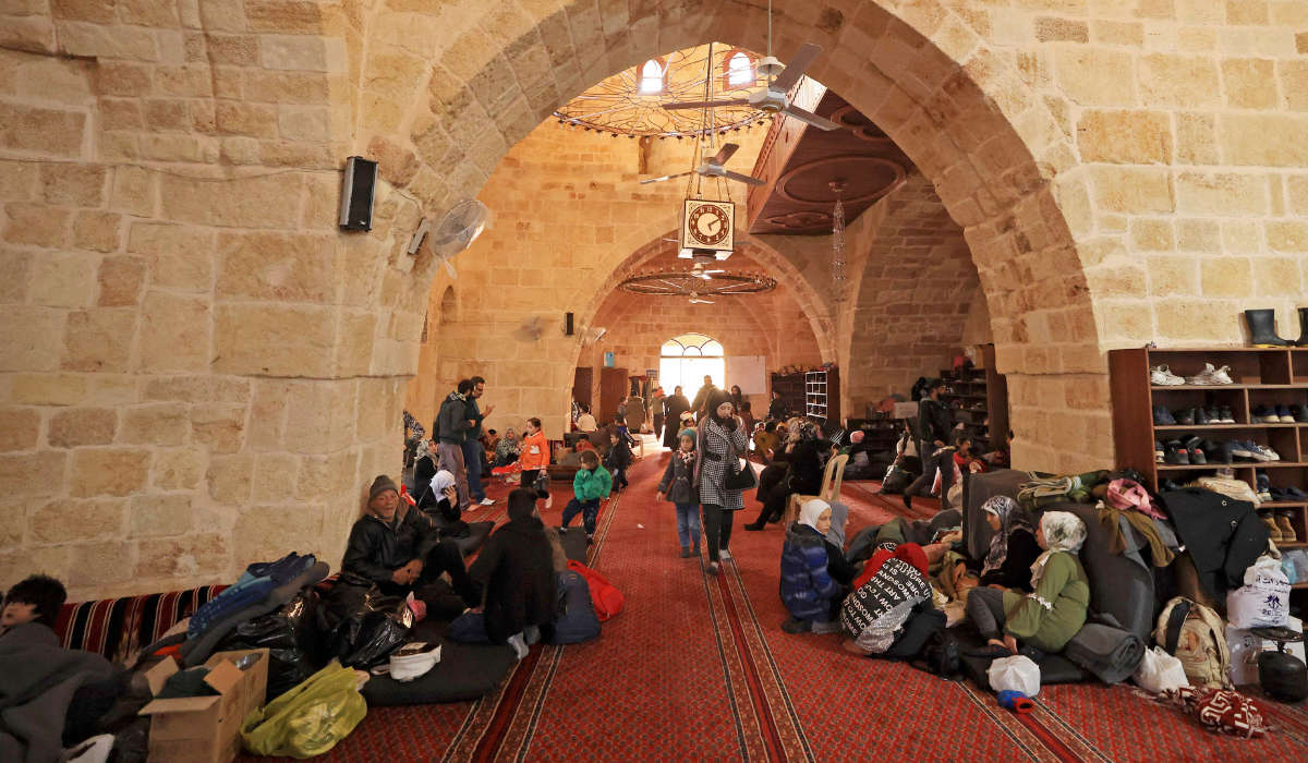 Displaced Syrians take refuge at the Sultan Ibrahim Mosque in the regime-controlled town of Jableh, northwest of the capital Damascus, on February 12, 2023 following a deadly earthquake in Turkey and Syria. (AFP)