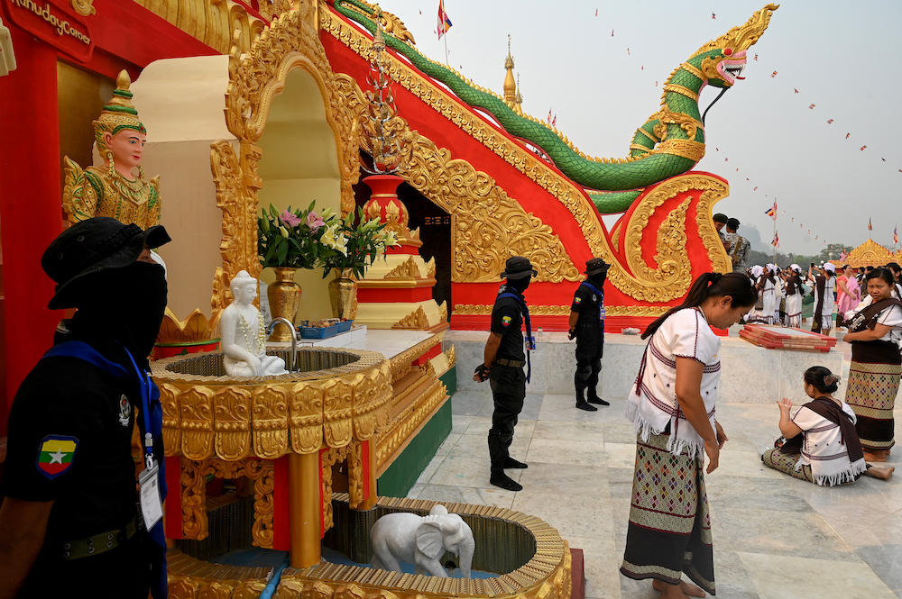 Above, Border Guard Forces stand guard as people gather for a Buddhist ceremony at Pyi Thar Lin Aye pagoda in Hlaingbwe township in Karen state on March 5, 2023. (AFP)