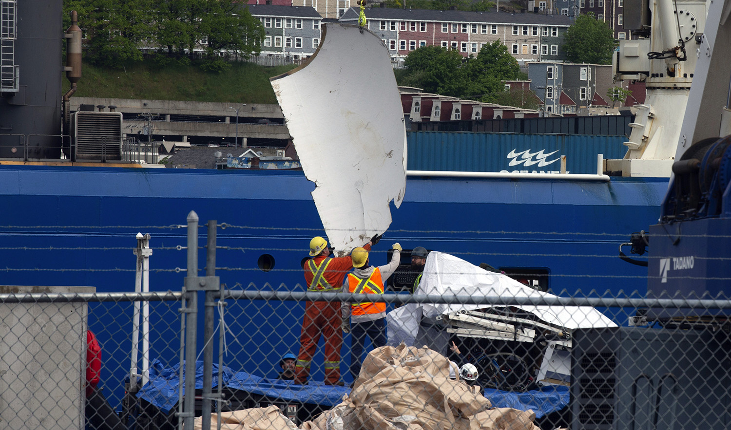 Debris from the Titan submersible, recovered from the ocean floor near the wreck of the Titanic, is unloaded from the ship Horizon Arctic at the Canadian Coast Guard pier in St. John's, Newfoundland, on June 28, 2023. (The Canadian Press via AP)