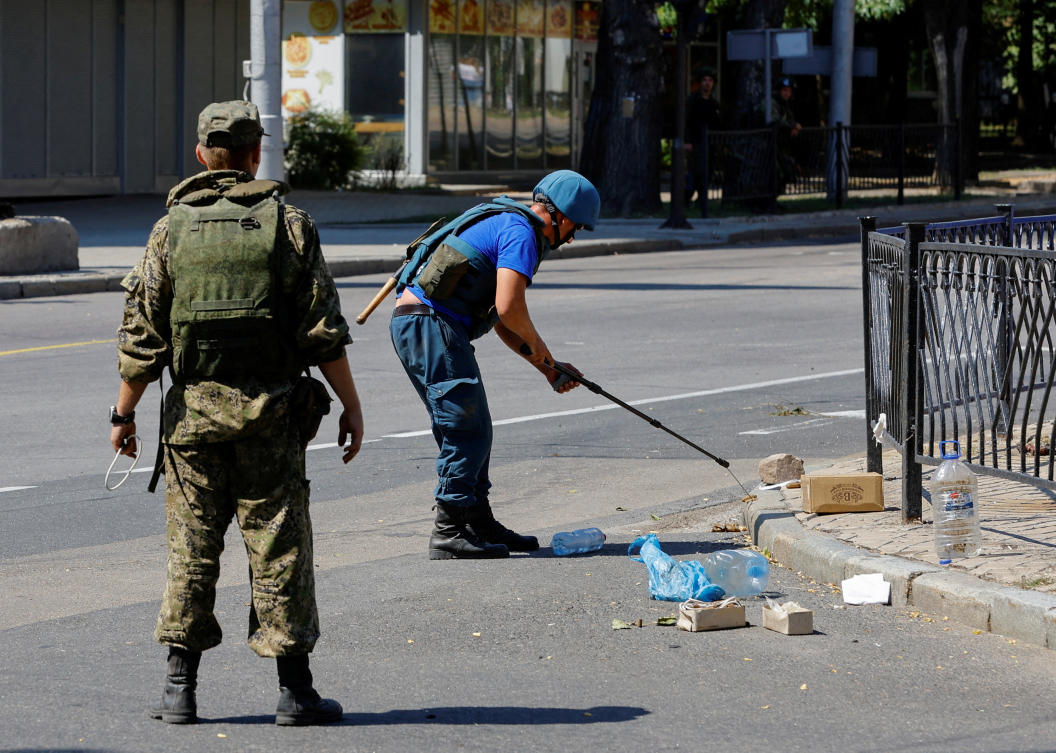 Combat engineers of pro-Russian troops demine PMF-1 Lepestok anti-personnel land mines in a street in Donetsk, Ukraine on July 31, 2022. (Reuters)