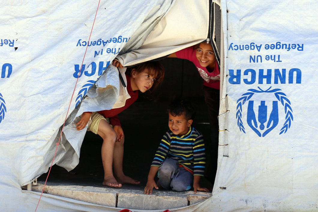 Syrian refugee children look from their tent at the Zaatari Refugee Camp, near Mafraq, Jordan. (AP/File)