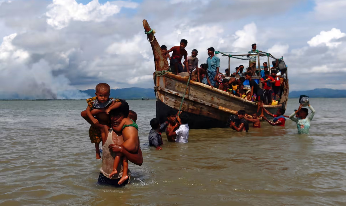Rohingya refugees from Myanmar get off a boat after crossing into Bangladesh through the Bay of Bengal. (Reuters/File)