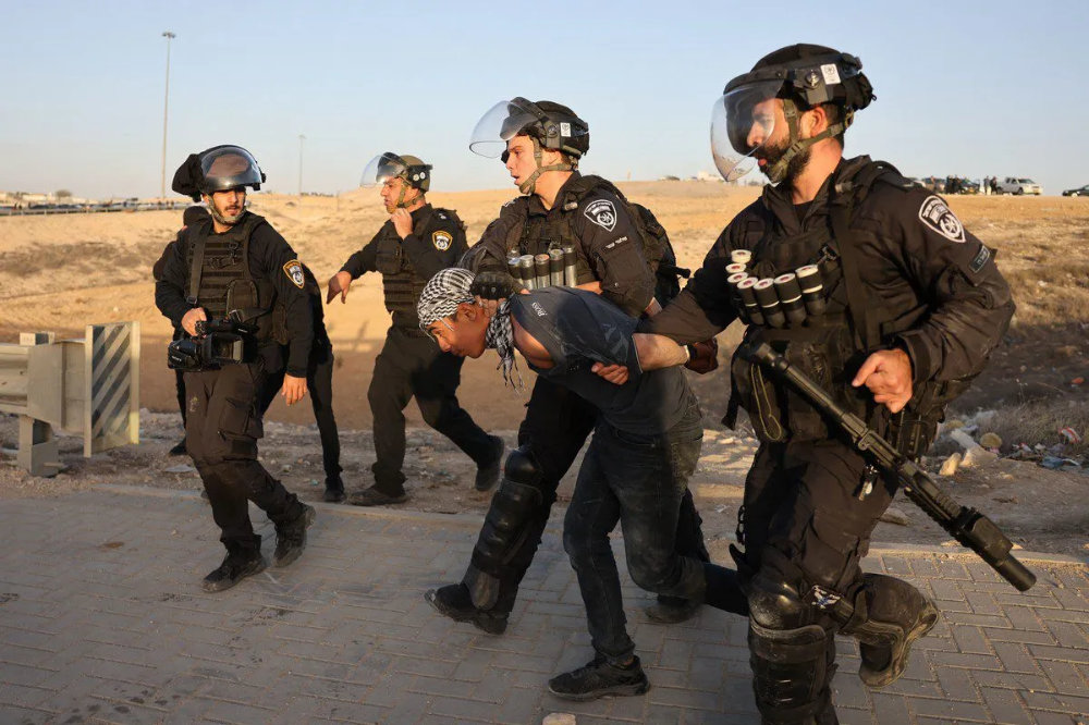 Israeli police arrest a Bedouin man in the village of Al-Atrash in the Negev desert. (AFP/File)