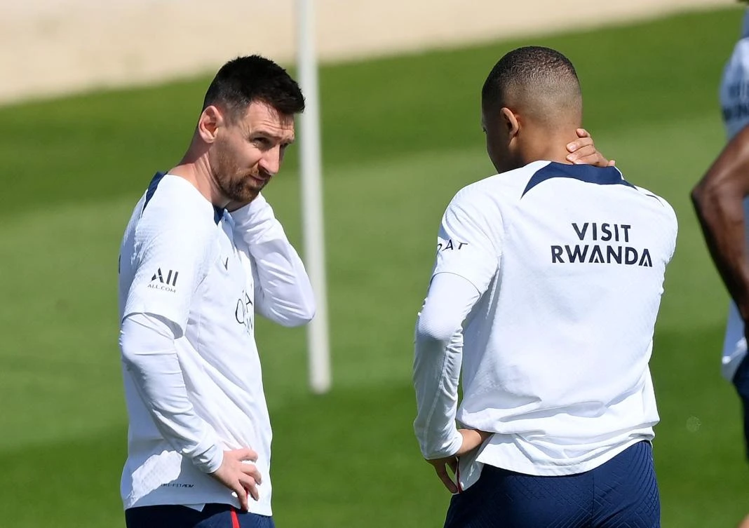 PSG’s Argentinian forward Lionel Messi speaks with French teammate Kylian Mbappe during a training session at the club’s training ground in Saint-Germain-en-Laye, Paris, on June 1, 2023. (AFP)