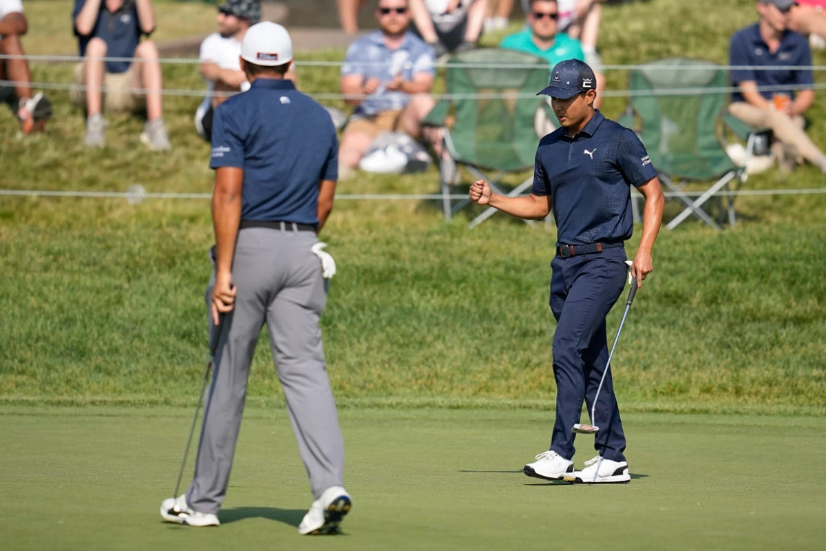 Justin Suh, right, reacts to a birdie on the 18th hole in front of Joseph Bramlett during the second round of the Memorial golf tournament Friday in Dublin, Ohio. (AP)