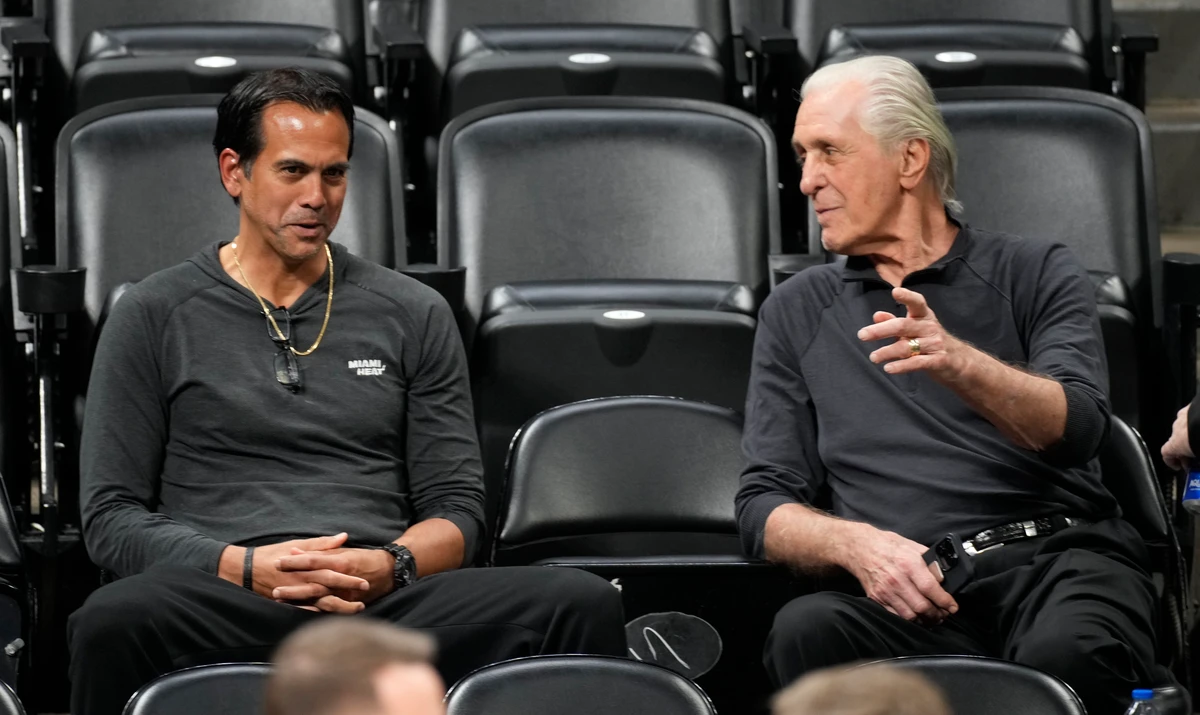 Miami Heat head coach Erik Spoelstra, left, chats with team president Pat Riley as they watch players practice for Game 2 of the NBA Finals, Saturday in Denver. (AP)